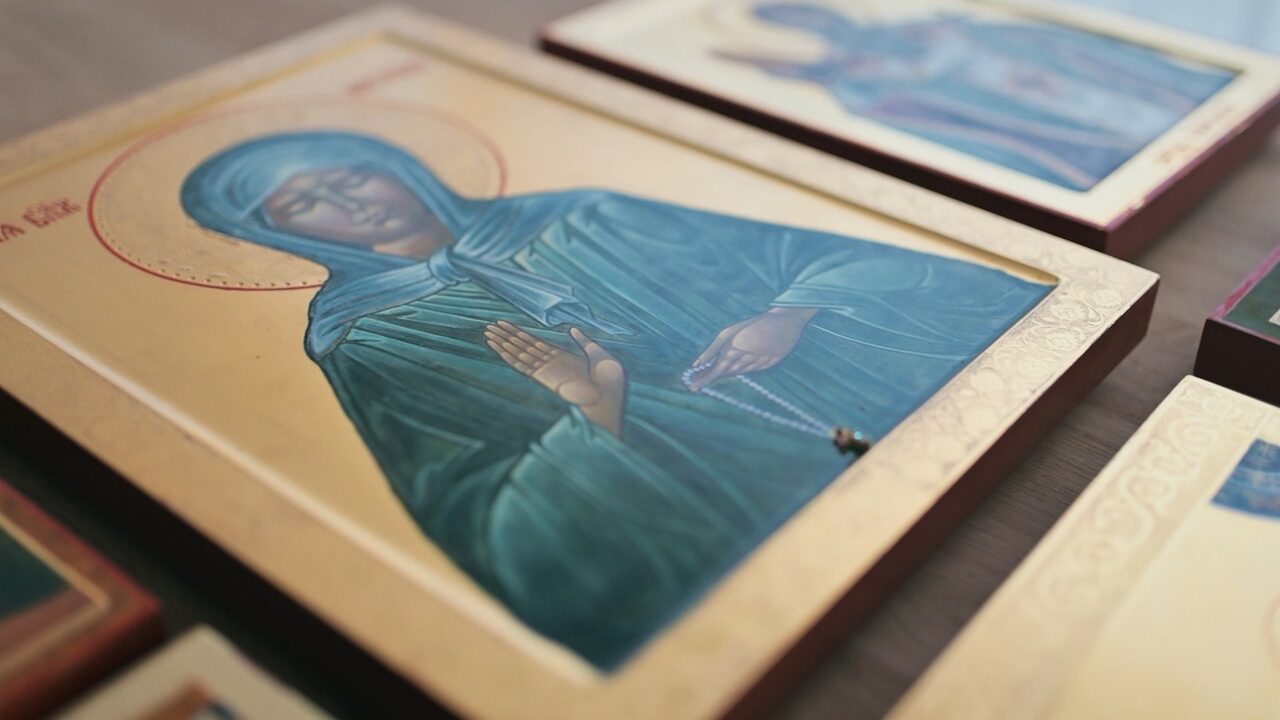 Finished icons lying on the studio work table, the nearest one the Mother of God in blue robes